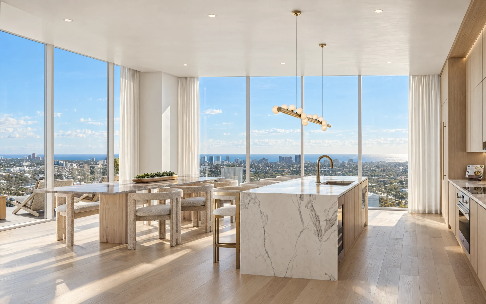 Residence interior with a marble kitchen island, dining area and city views