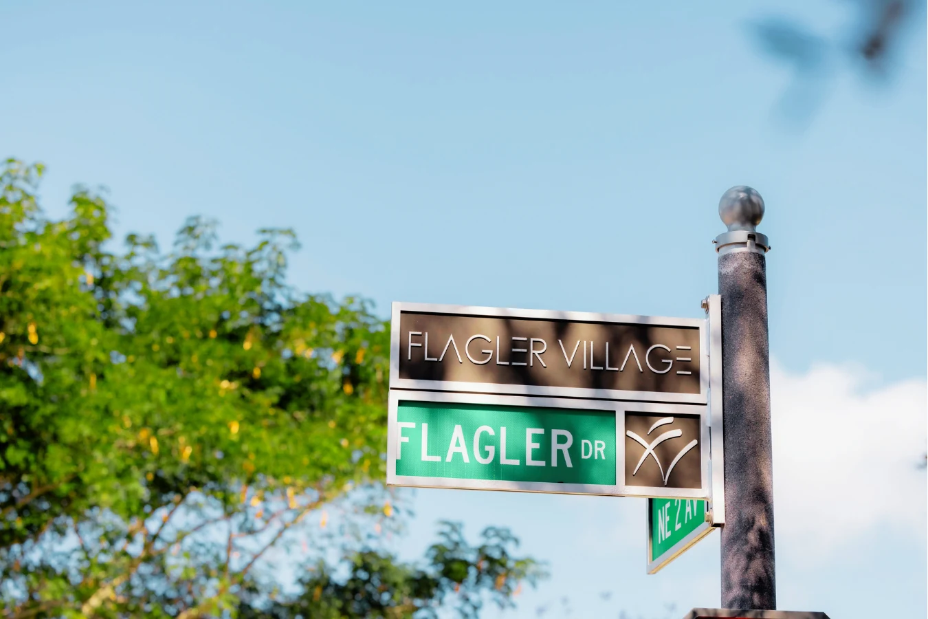 Flagler Drive street sign among palm trees near Ombelle
